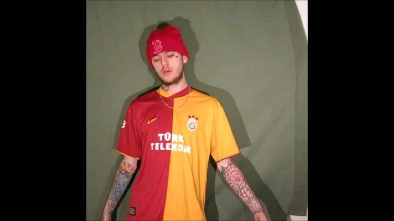 lil peep is wearing red and yellow tshirt and red cap standing in forest green background having tattoos on hands music, HD wallpaper