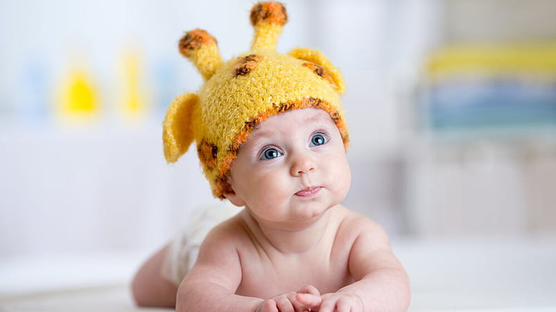 Blue Eyes Cute Baby Child Is Lying Down On Floor Wearing Yellow Woolen  Knitted Cap In Blur Background Cute, HD wallpaper | Peakpx