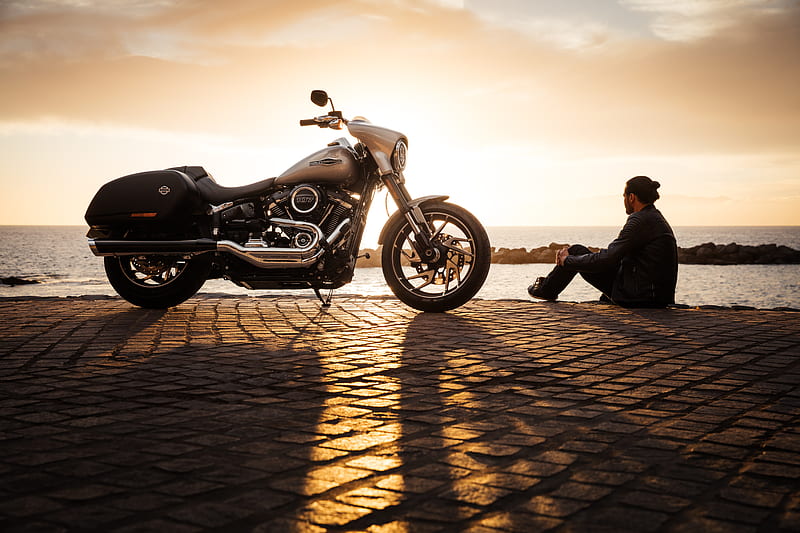 man sitting on ground beside parked silver cruiser motorcycle, HD wallpaper