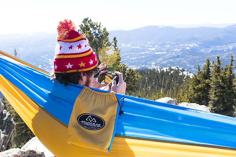 man in red and white bobble knit cap on blue and yellow hammock, HD wallpaper