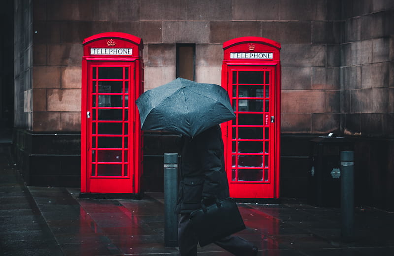 person under umbrella walking beside telephone booths, HD wallpaper