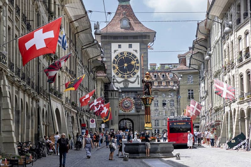 The Zytglogge is a landmark medieval tower in Bern, Switzerland. , clock tower, old city of Bern, bus, people, flags, HD wallpaper