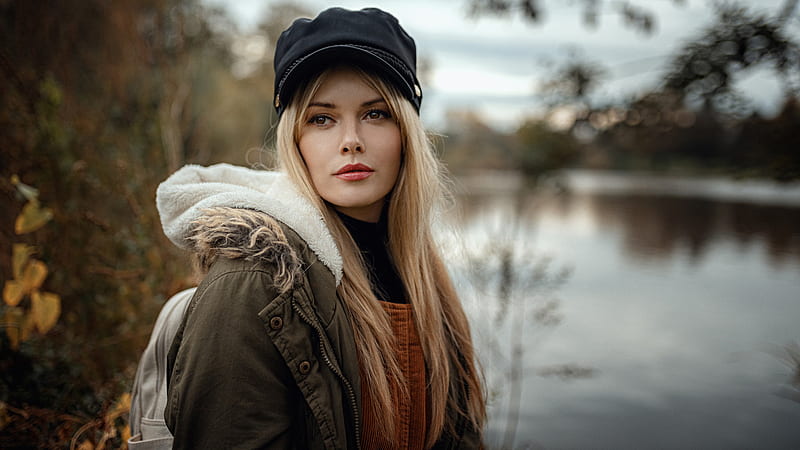 Blonde Carla Monaco Is Wearing Black Hat And Overcoat Standing In Blur River Background Girls, HD wallpaper