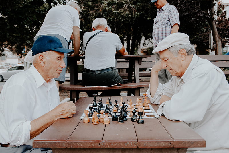 Download A Person Is Playing Chess On A Board Wallpaper