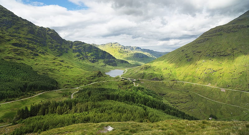 Lake in a beautiful green valley, roads, grass, mountains, forests ...