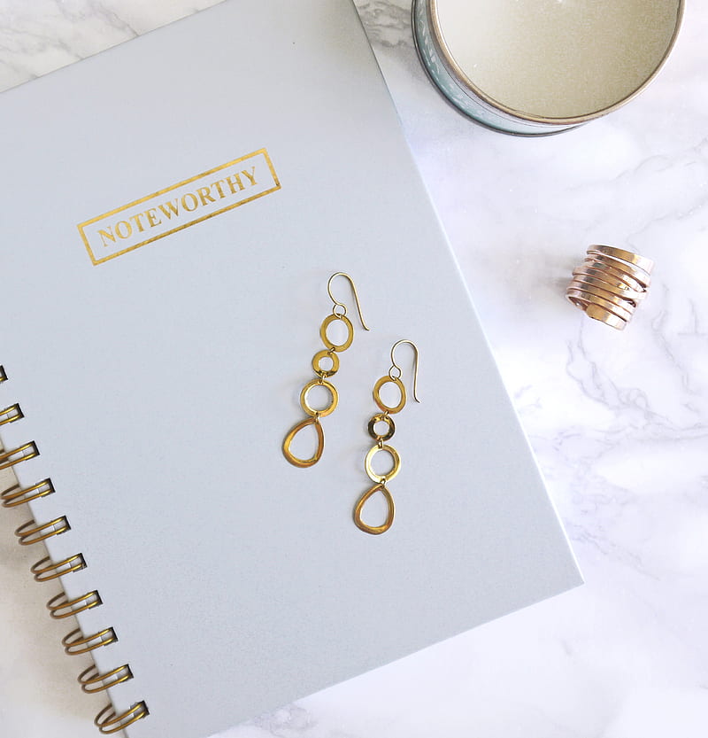 pair of gold-colored dangling hook earrings on top of spiral notebook, HD phone wallpaper