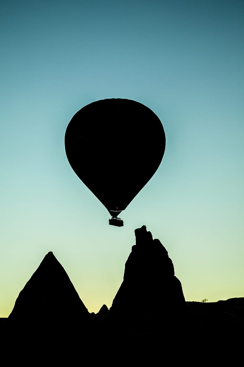 silhouette of hot air balloon flying above rock formation, HD phone wallpaper