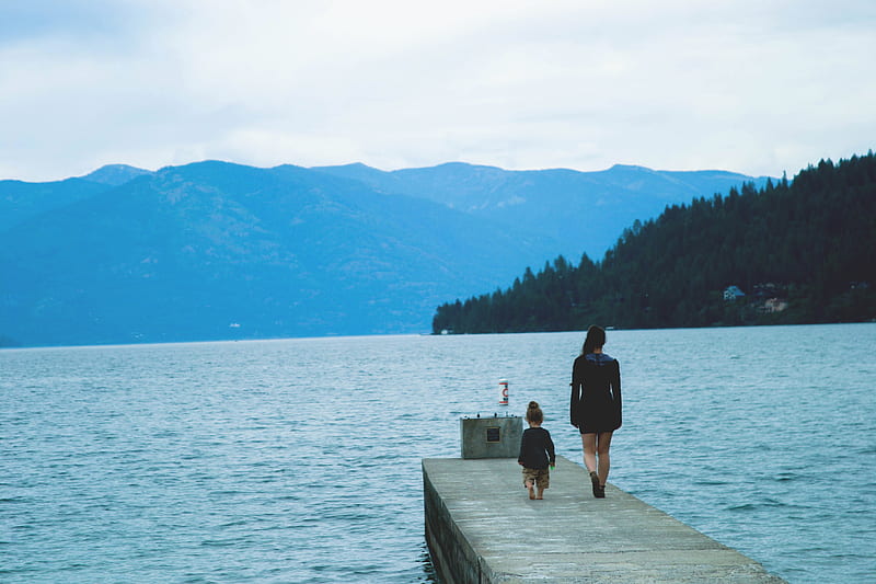 woman and girl walking along concrete dock surrounded by body of water, HD wallpaper