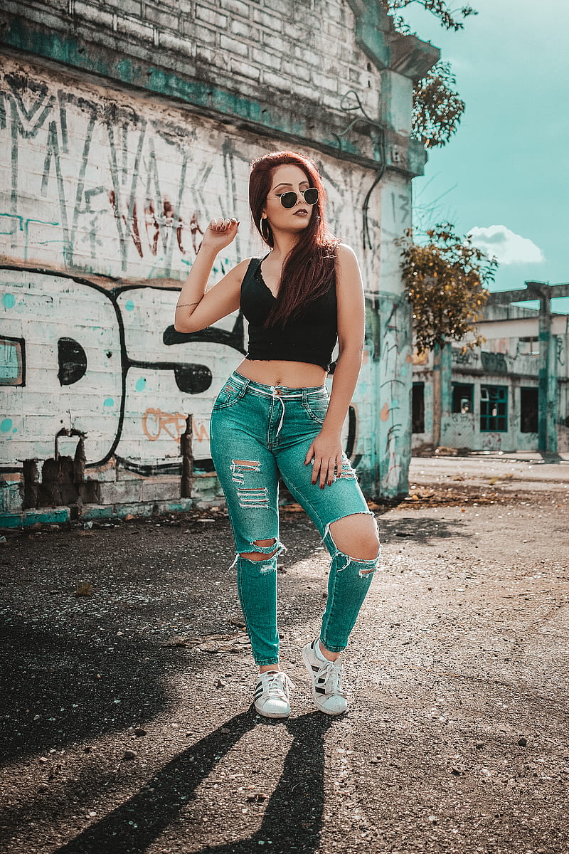 woman wearing black V-neck sleeveless top and distressed blue denim pants outfit while taking, HD phone wallpaper