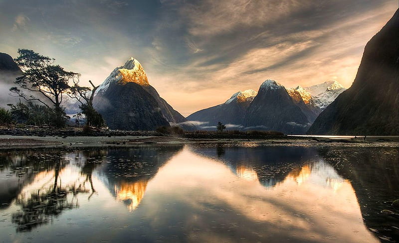 Snowy Peaks Reflections At Sunrise, dawn, National Park, UNESCO World Heritage Site, bonito, trees, sky, clouds, Milford Sound, morning calm, snow, mountains, fjord, New Zealand, sunrise, HD wallpaper