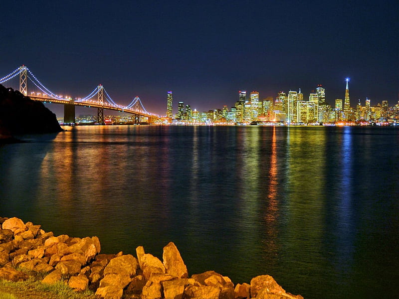 San Francisco skyline, shore, dusk, twilight, lights, stones, bridge, skyline, america, evening, reflection, night, buildings, sky, san francisco, water, summer, nature, HD wallpaper
