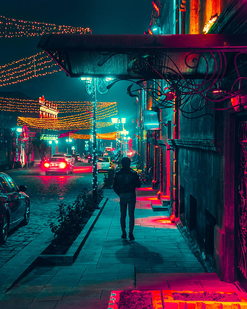 man walking along a sidewalk during nighttime, HD phone wallpaper