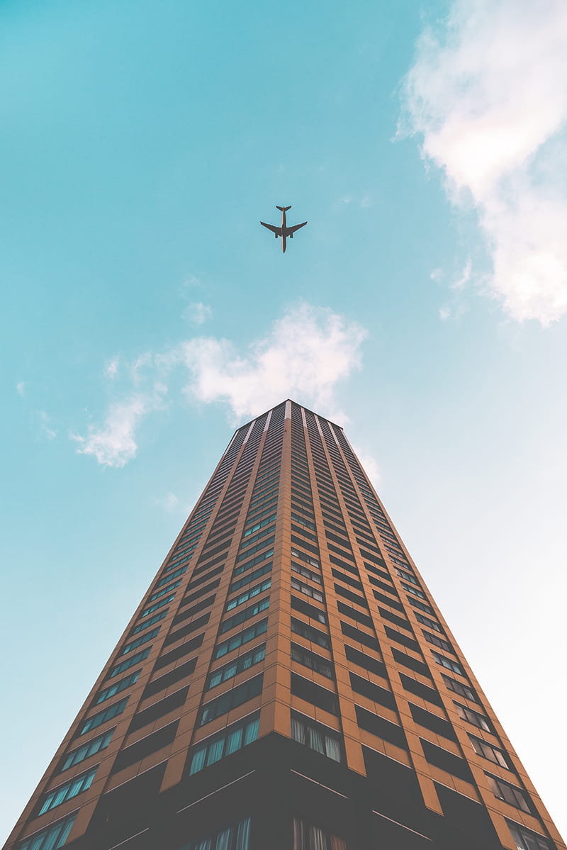 bottom view shot of airplane flying above high rise building, HD phone wallpaper