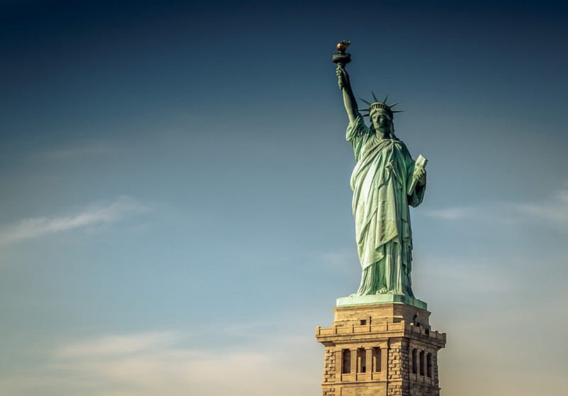 Statue of Liberty on Ellis Island, New York City, New York. Color daytime  landscape photo, statue is in center of frame, ample copy space in sky  Stock Photo - Alamy
