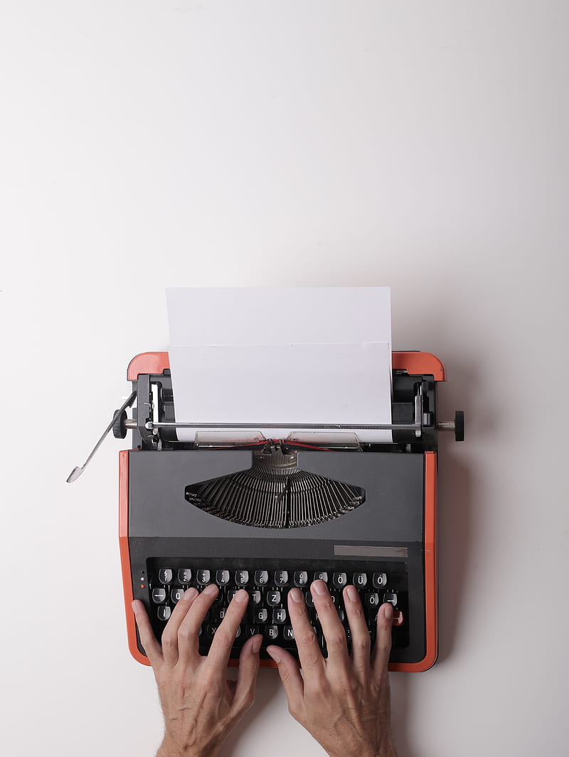 From above crop person using vintage black and red typewriter with white blank sheet of paper against white background, HD phone wallpaper