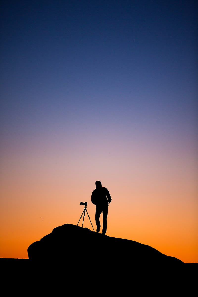 silhouette of person standing beside DSLR camera with stand at sunset, HD phone wallpaper