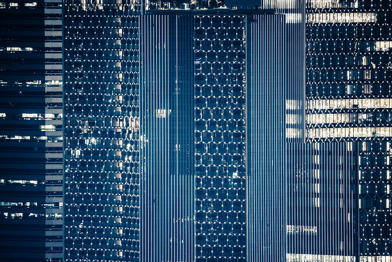 Macro of skyscraper's windows that are framed by light in honeycomb pattern, HD wallpaper
