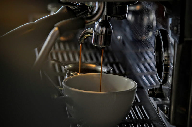 Espresso dripping into a porcelain mug from a steel machine, HD wallpaper