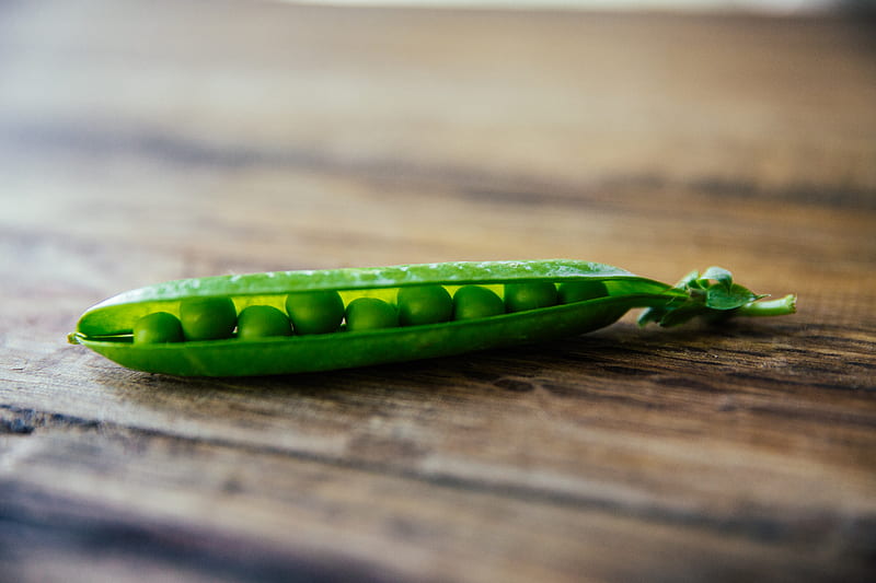 shallow focus graphy of green pea on brown wooden surface, HD wallpaper