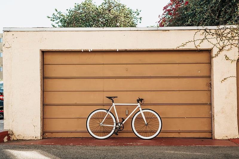 white bike leaning on brown roller shutter, HD wallpaper