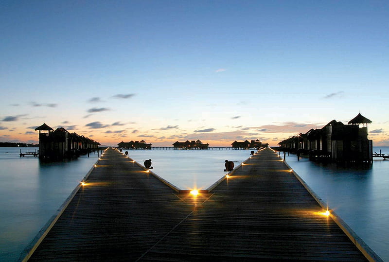 Sunset Pier........., lit, dusk, sunset, villa, sea, lights, beach, lagoon, walkway, bungalows, evening, blue, exotic, islands, ocean, pier, water, paradise, island, tropical, villas, HD wallpaper
