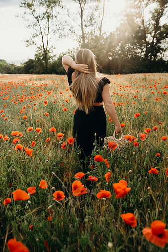 Woman in black red and white floral spaghetti strap dress standing on green  grass field during photo – Free September Image on Unsplash