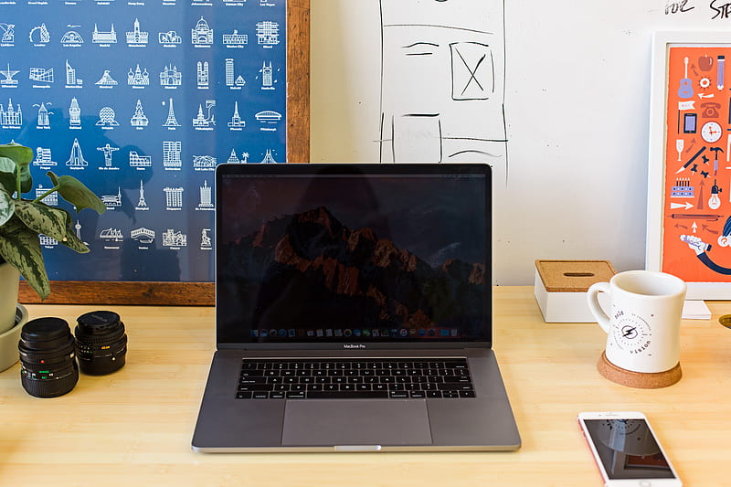 Macbook Pro on table near white mug and PRODUCT RED iPhone, HD wallpaper