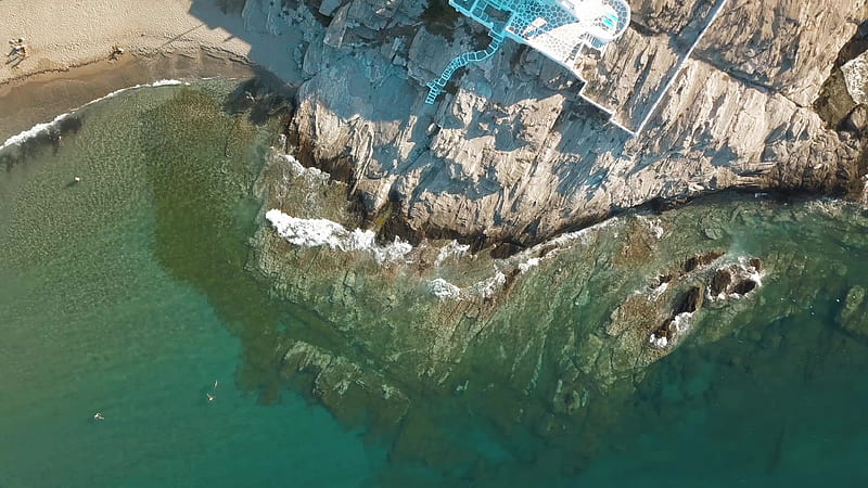 aerial view of gray and white rock formation beside body of water during daytime, HD wallpaper