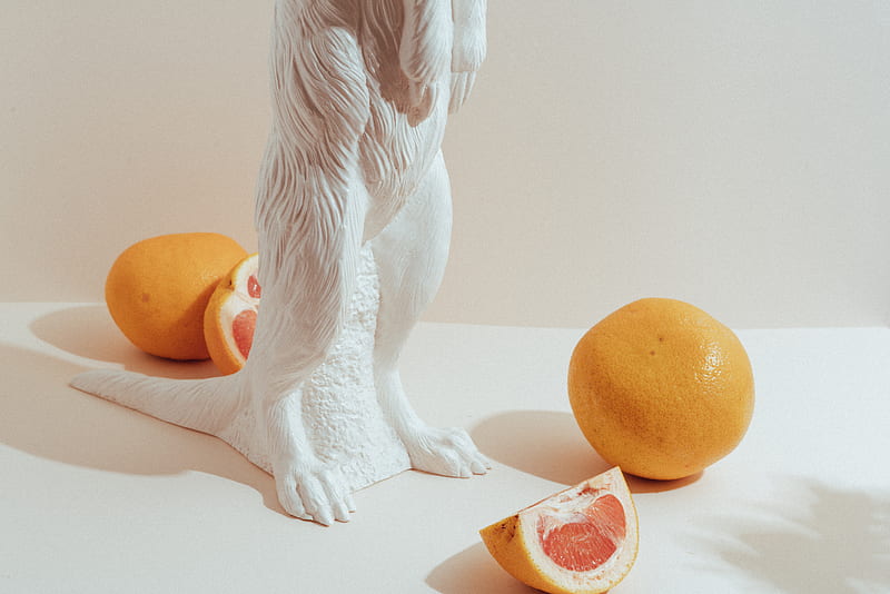 white angel figurine beside orange fruit, HD wallpaper