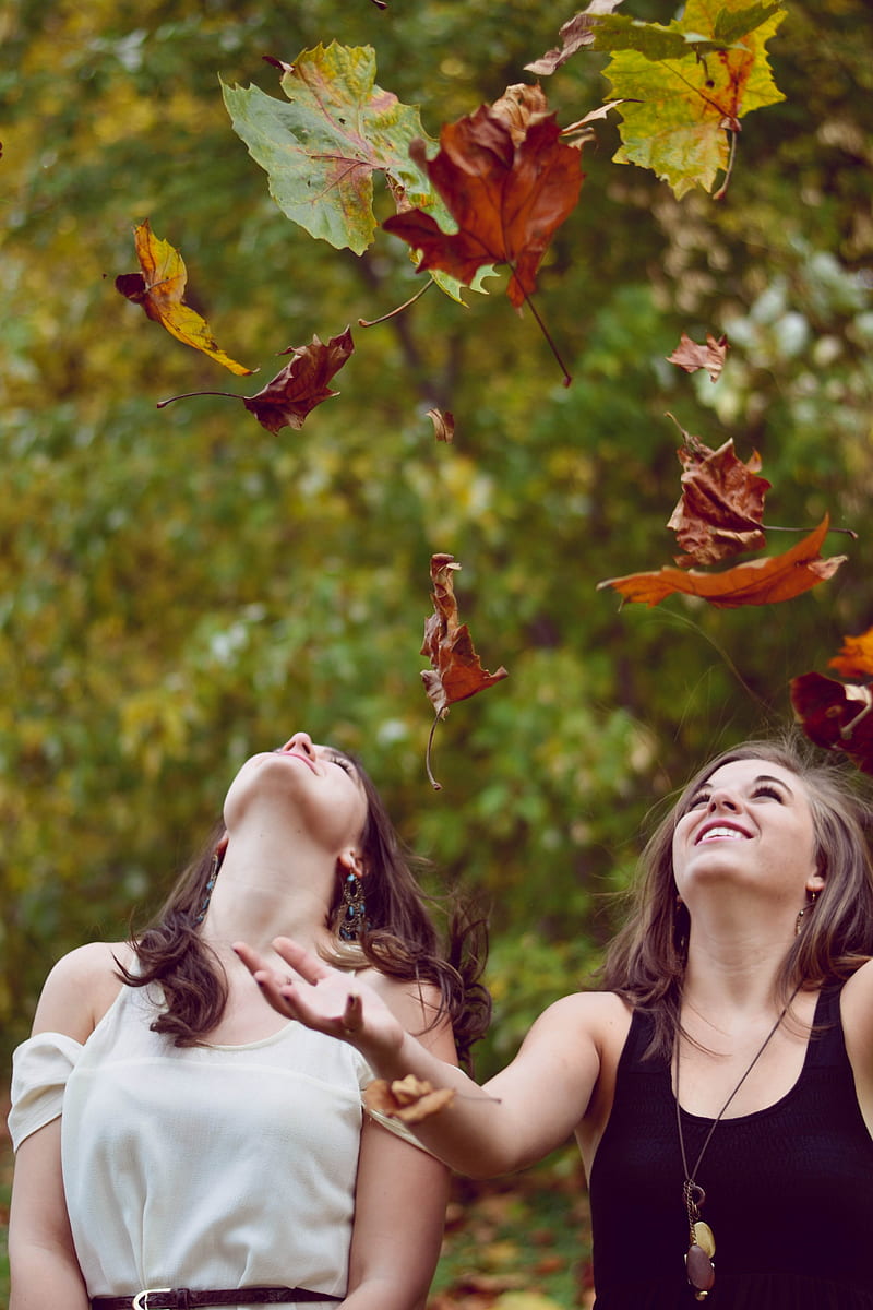 two women throwing leaves during daytime, HD phone wallpaper