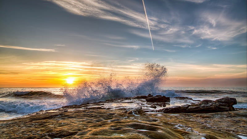 wave breaking on rocky shore at sunset, rocks, shore, sunset, plane trail, sea, wave, HD wallpaper