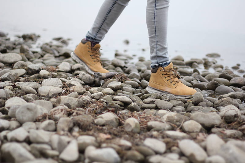 person wearing brown shoes walking through stoned seashore, HD wallpaper