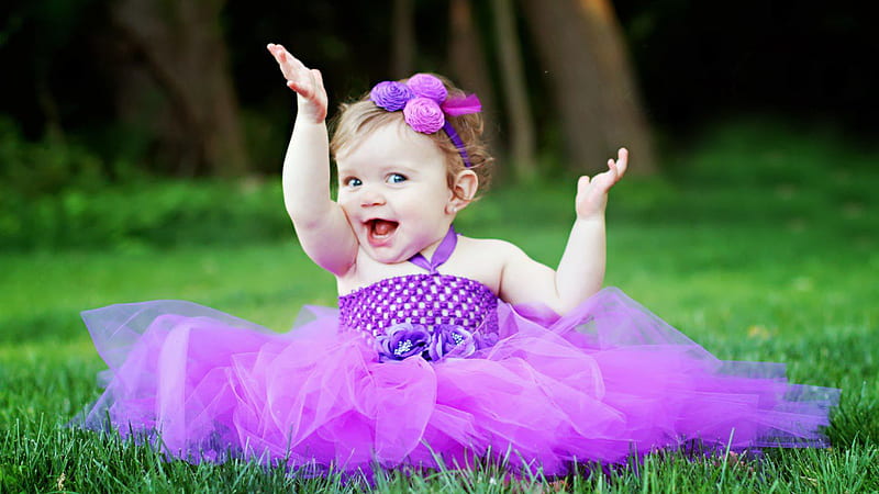 Cute Smiley Girl Baby Is Sitting On Green Grass Wearing Purple Frock And Flower Band On Head Having Hands In The Air Cute, HD wallpaper