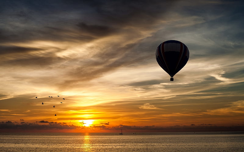 Gentle Ride, bird flock, gray, orange, yellow, sunset, floating, silhouette, clouds, water, boat, hot air balloon, gris, peaceful, reflection, blue, HD wallpaper