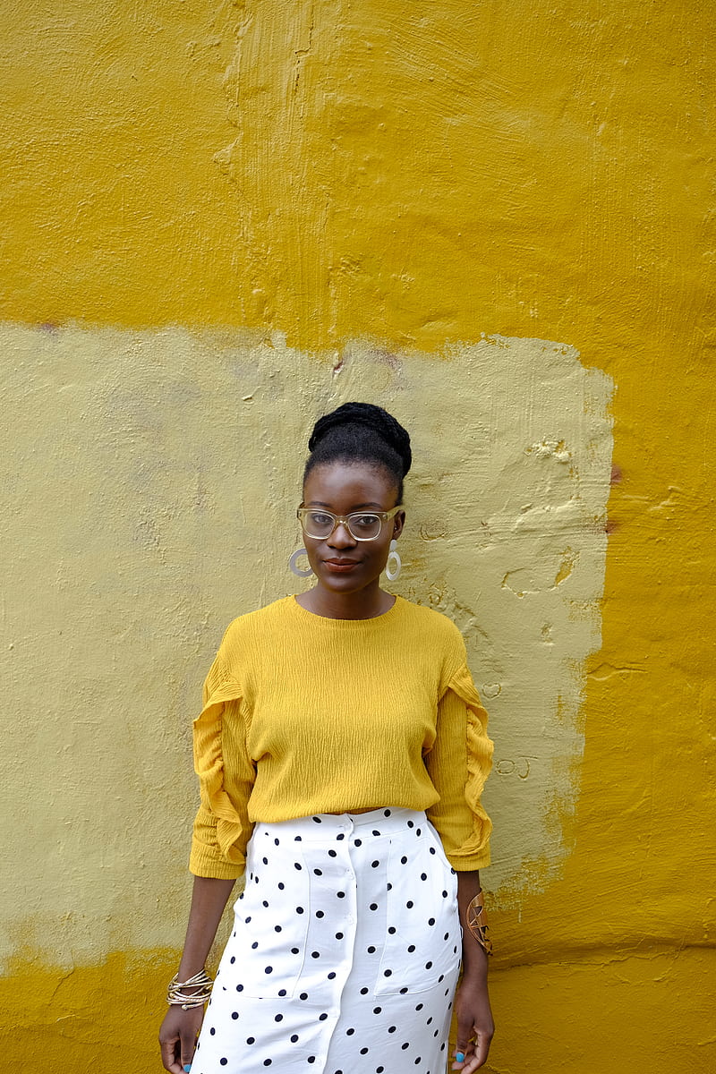 woman in yellow crew neck long sleeve shirt leaning on yellow painted wall, HD phone wallpaper