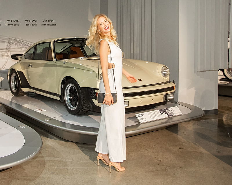 Athena Brensberger picking out her Porsche, bracelet, porsche 911, honey blonde, long strap, earring, heels, wooden flooring, small handbag, car showroom, white pants suit, HD wallpaper