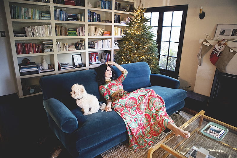 Abigail Spencer, ornaments, christmas tree, floor to ceiling book shelve, books, feet on glass top coffee table, patterned dress, white scottie dog, brunette, fireplace, french doors, royal blue sofa, HD wallpaper