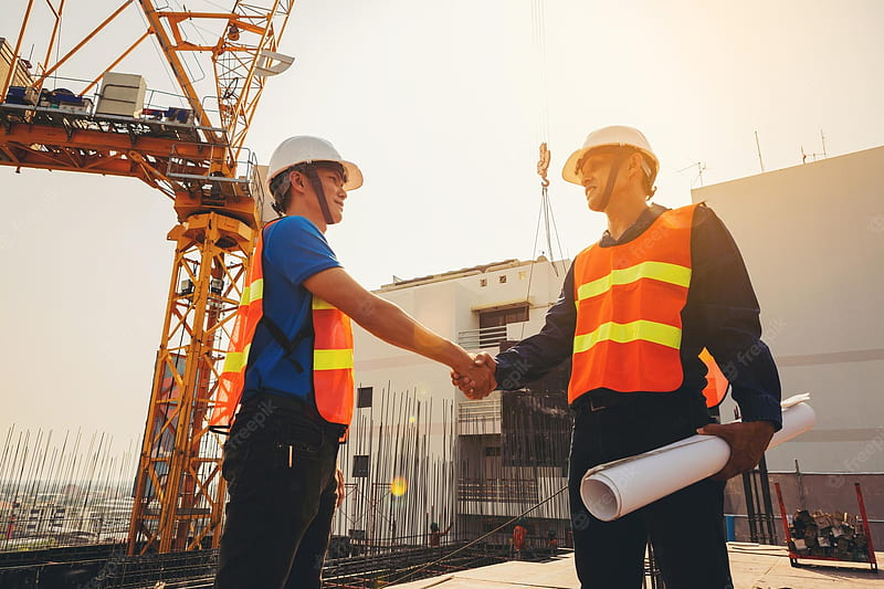 Premium . Architect and engineer construction workers shaking hands while working outdoors construction site, HD wallpaper