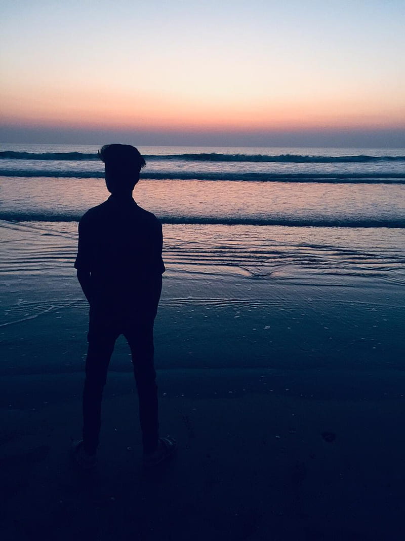 Man wearing hoodie on beach hi-res stock photography and images