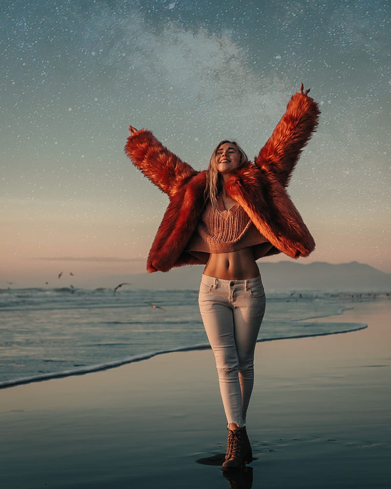Carly Belle, blonde, women, model, belly, jeans, portrait, sweater, sea, women on beach, smiling, fur, arms up, sky, women outdoors, closed eyes, red coat, belly button, slim body, pierced nose, HD phone wallpaper
