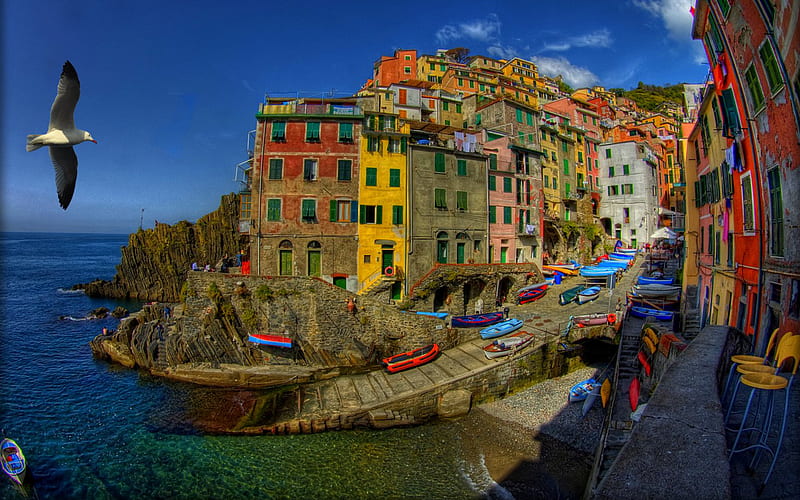 Riomaggiore, Italy, architecture, colorful, house, sailing, sunny, riomaggiore, bonito, clouds, sea, italia, boats, boat, splendor, chairs, beauty, way, chair, italy, lovely, view, houses, town, colors, waves, sky, water, bird, peaceful, nature, alley, sailboat, sailboats, HD wallpaper