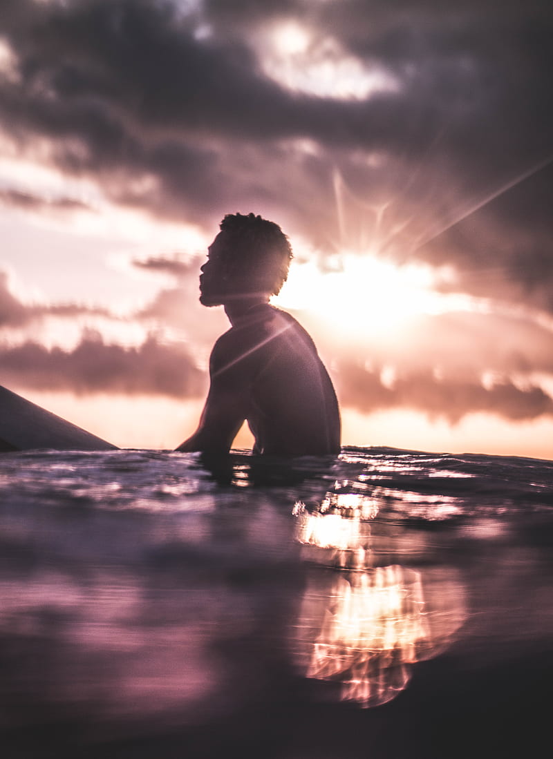 Unrecognizable black man relaxing in sea water at sundown, HD phone wallpaper