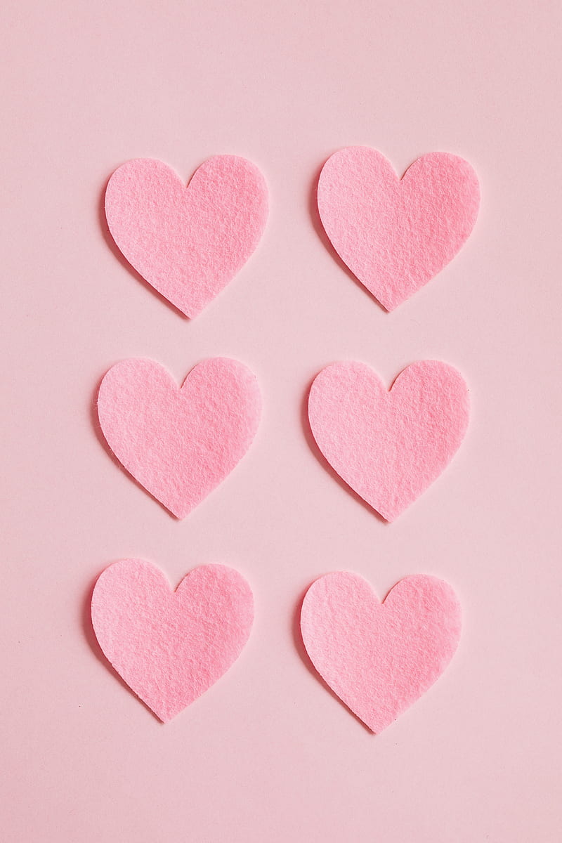 Top view close up composition made with bright pink hearts cut out of pink rough paper and arranged in lines on light pink background, HD phone wallpaper