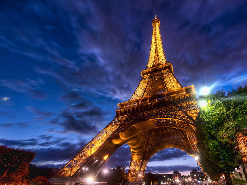Eiffel Tower, architecture, dramatic, monuments, paris, clouds, lights, tower, beauty, eiffel, evening, lovely, lanterns, romance, loved part of paris, beautiful view, buildings, sky, trees, building, france, colorful, lantern, bonito, graphy, city, green, blue, romantic, view, colors, eifel tower, tree, peaceful, blue sky, nature, HD wallpaper