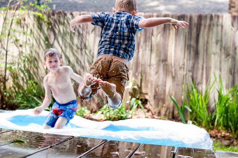 two boys playing in inflatable pool during daytime, HD wallpaper