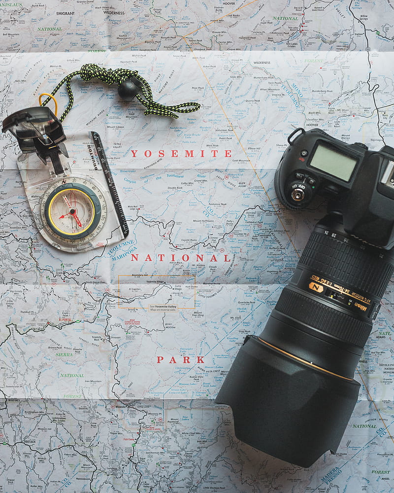 black Nikon DSLR camera beside of map compass, HD phone wallpaper