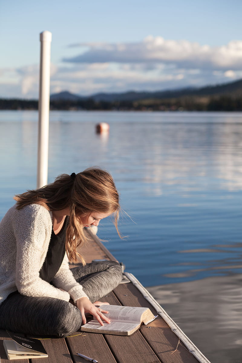 woman reading book near body of water, HD phone wallpaper