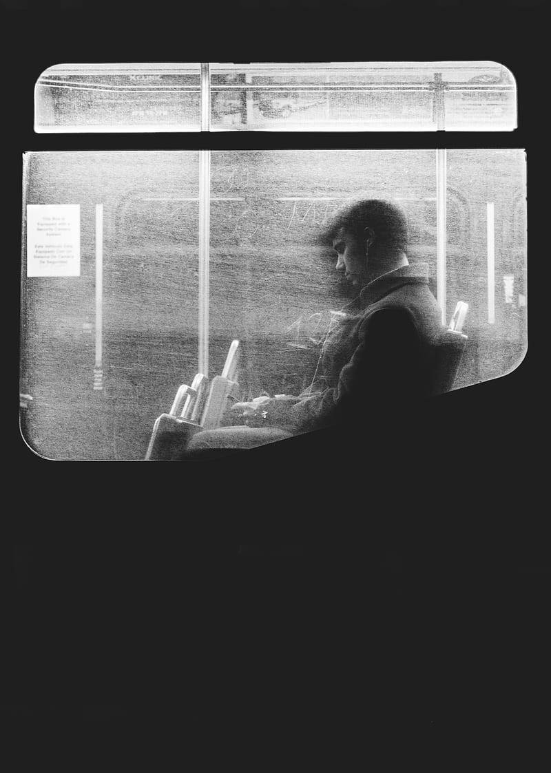 Black and white shot of man sitting on night bus through dirty window in Boston, HD phone wallpaper