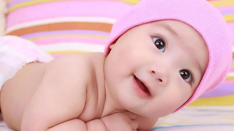 Cute Little Baby Is Lying Down On Bed Wearing Pink Woolen Knitted Cap Cute, HD wallpaper