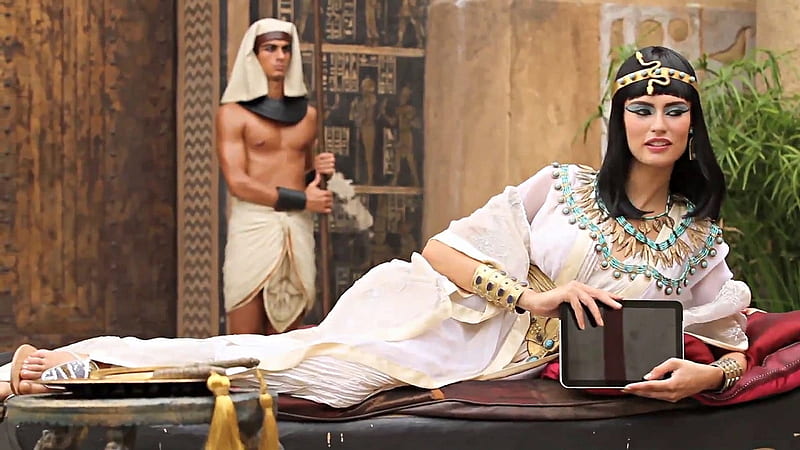 Bianca Balti as Cleopatra, tassels, palace guard, bracelets, posing on day bed, head band, necklaces, spear, black hair, white patterned gown, HD wallpaper